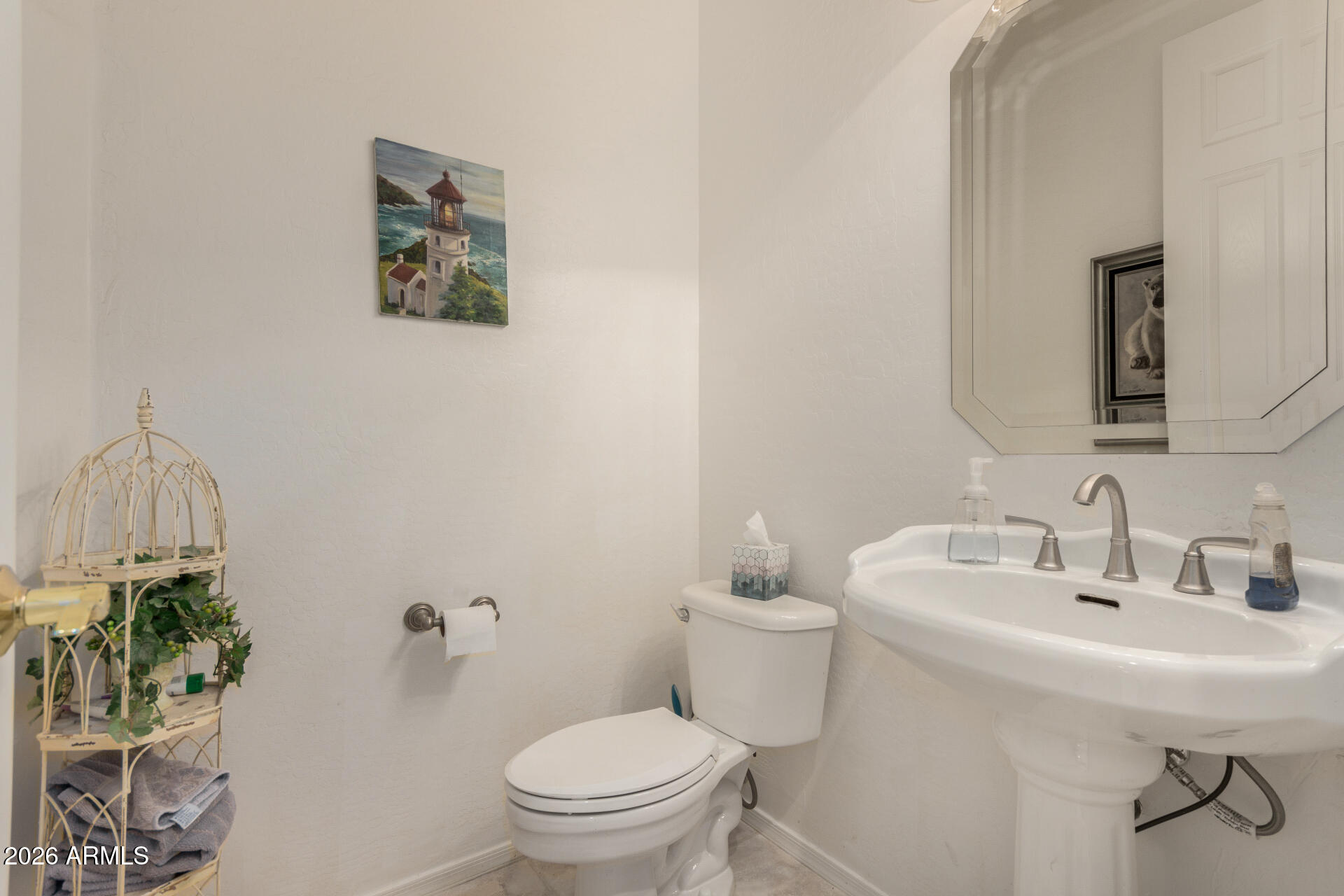 4419 East Robin Lane Phoenix, AZ 85050 - Photo 24 of 28 a bathroom with a toilet a sink and mirror