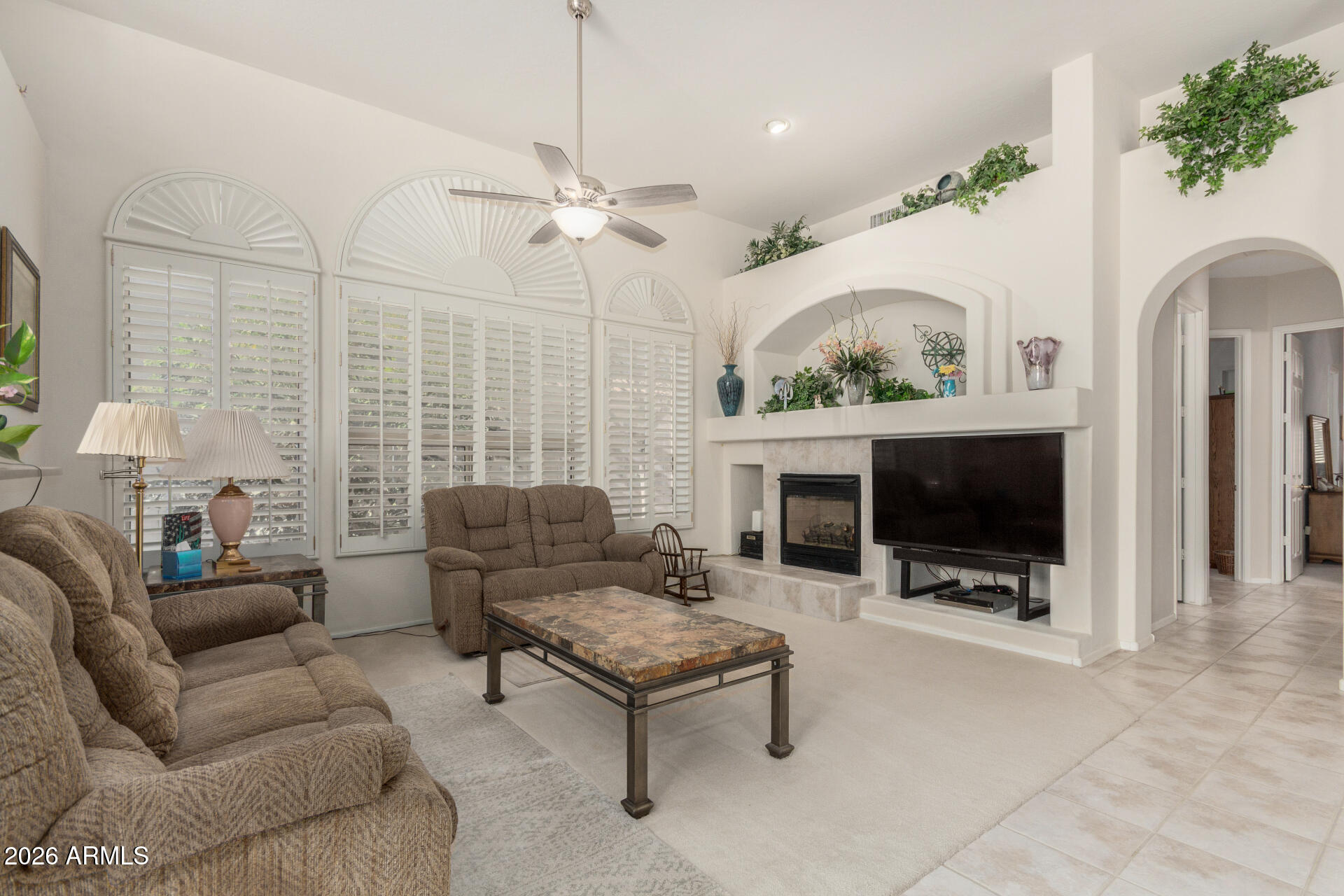 4419 East Robin Lane Phoenix, AZ 85050 - Photo 7 of 28 a living room with furniture a flat screen tv and a fireplace
