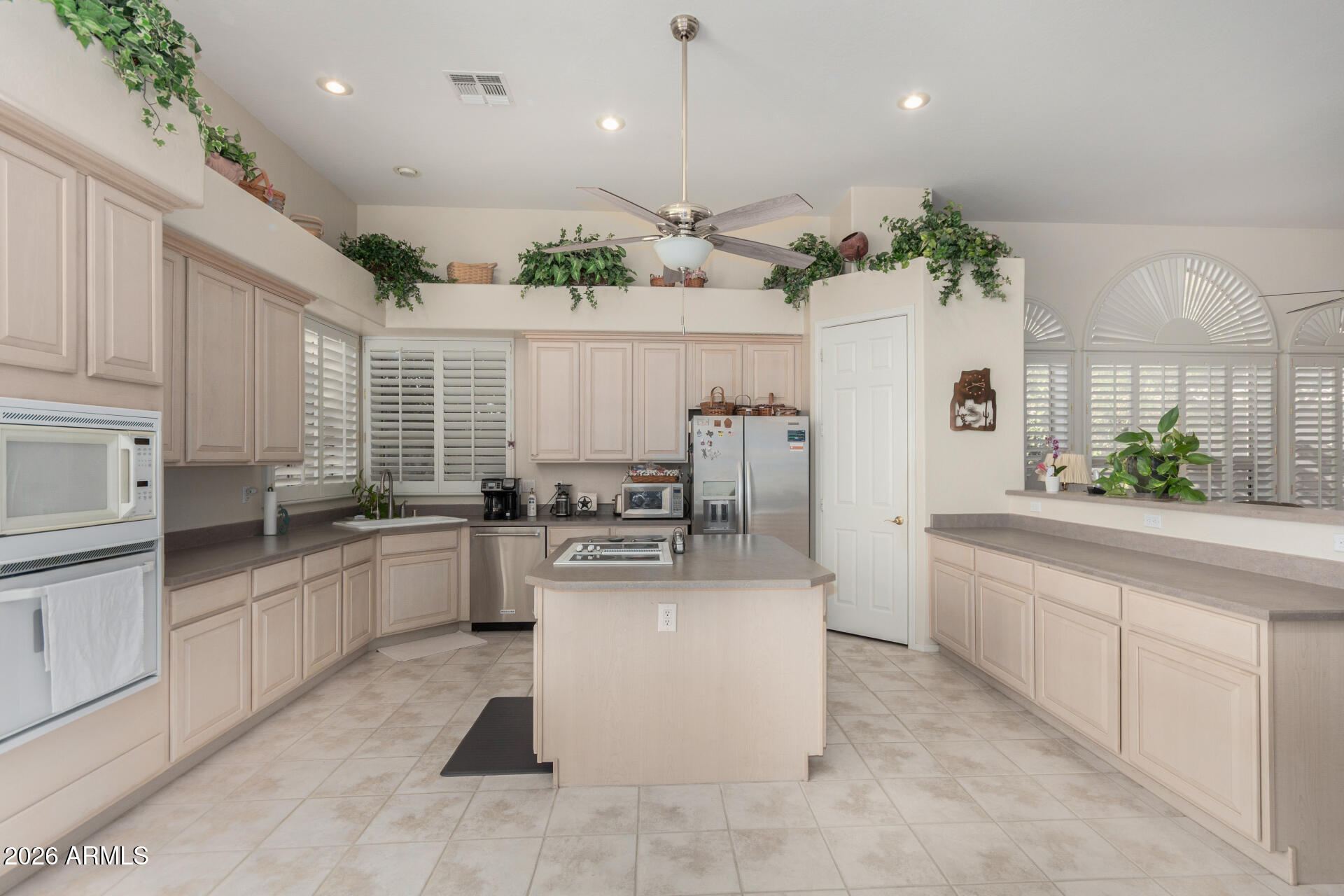 4419 East Robin Lane Phoenix, AZ 85050 - Photo 10 of 28 a large white kitchen with lots of counter space and stainless steel appliances