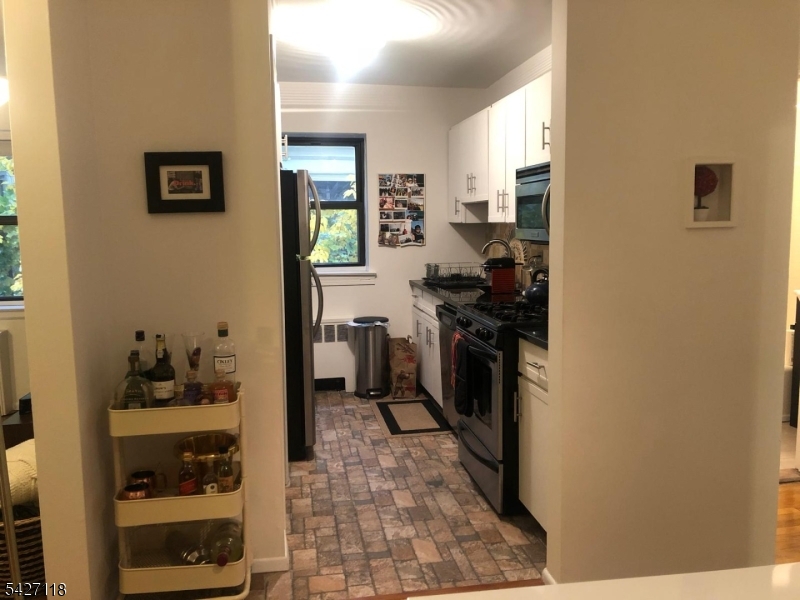 130 Orient Way, Unit 2K Rutherford, NJ 07070 - Photo 6 of 16 a kitchen with a sink and cabinets