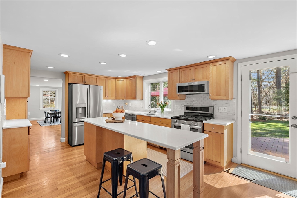 13 Mohegan Road Acton, MA 01720 - Photo 6 of 39 a kitchen with stainless steel appliances a stove a sink a refrigerator white cabinets and wooden floor