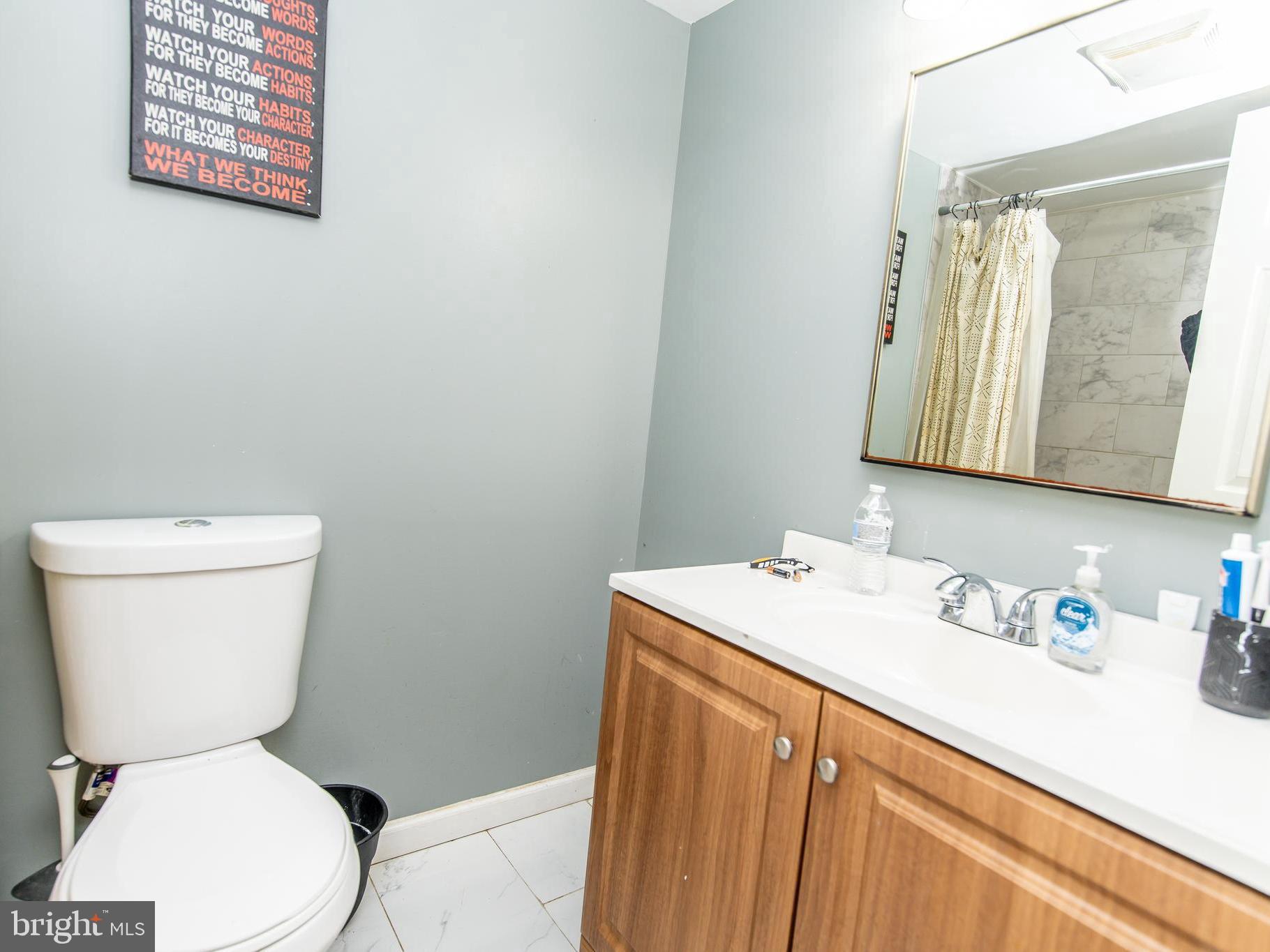 3934 Bel Pre Road, Unit 39342 Silver Spring, MD 20906 - Photo 21 of 30 a white toilet sitting next to a bathroom sink