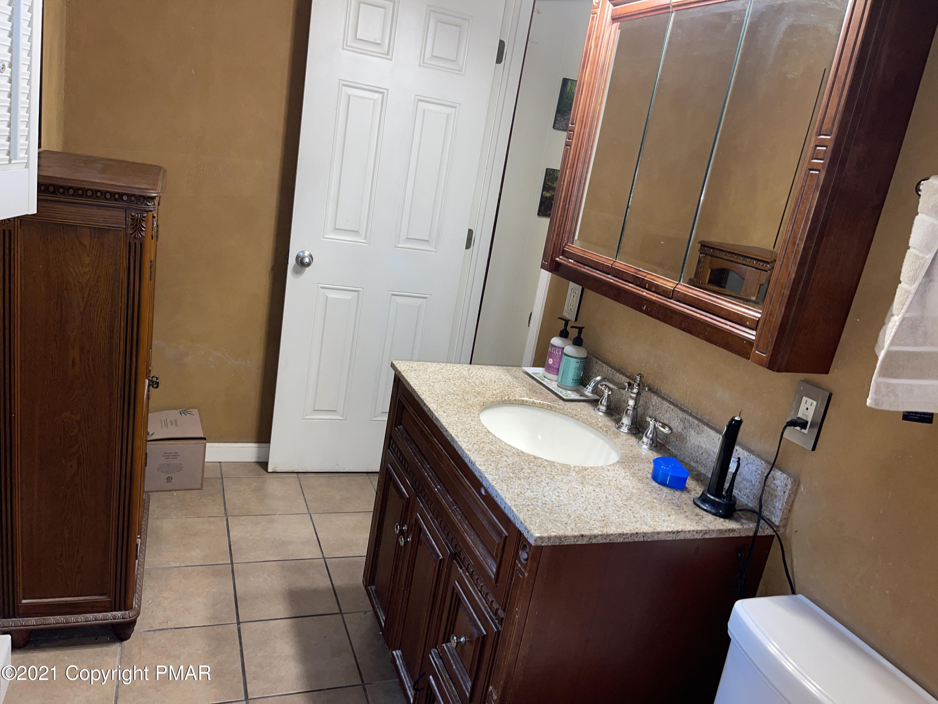 6113 Decker Road Bushkill, PA 18324 - Photo 8 of 26 a bathroom with a sink and a mirror