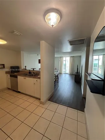 a kitchen with cabinets and wooden floor