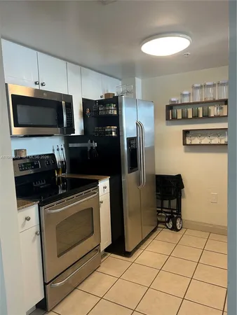 a kitchen with stainless steel appliances a stove a microwave and a refrigerator