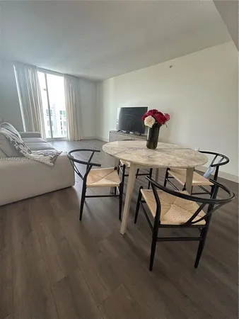 a view of a dining room with furniture and window