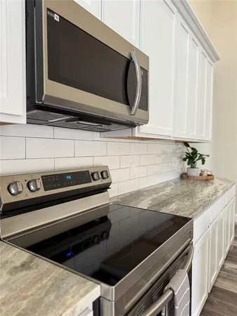 a kitchen with a stove microwave and cabinets