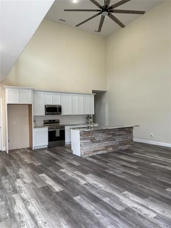 a view of a kitchen with a stove cabinets and wooden floor