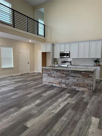 a kitchen with kitchen island cabinets and a sink