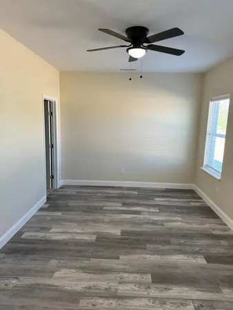 a view of empty room with ceiling fan