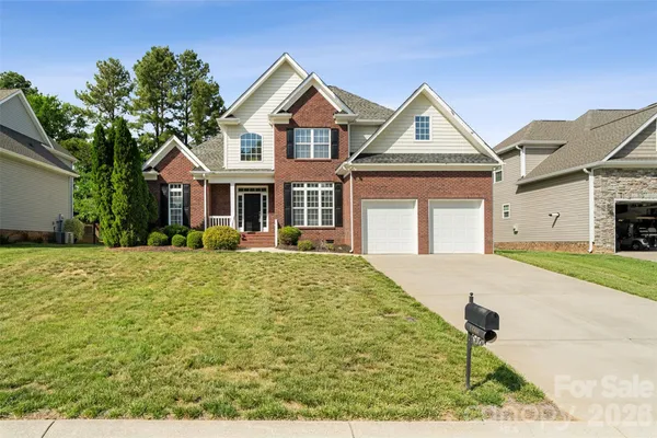 a front view of a house with yard