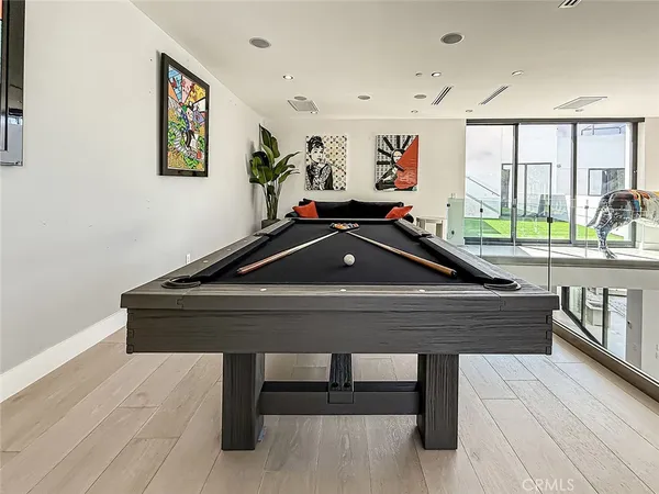 a room with furniture pool table and windows