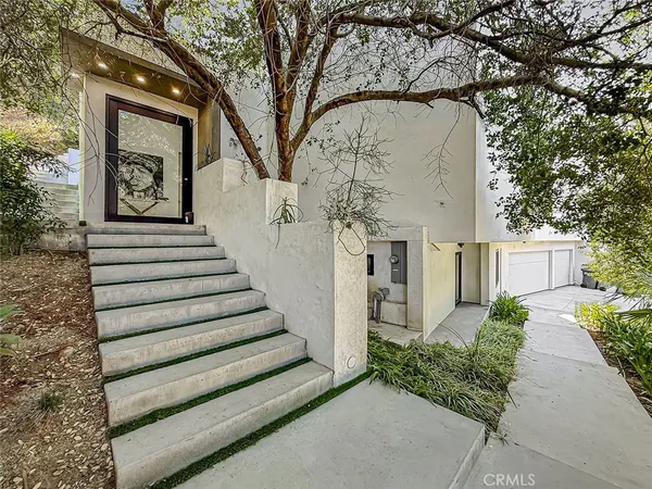 a view of a house with a large tree