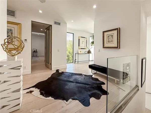 a room with a black white checkered floor with a black white bedspread and table