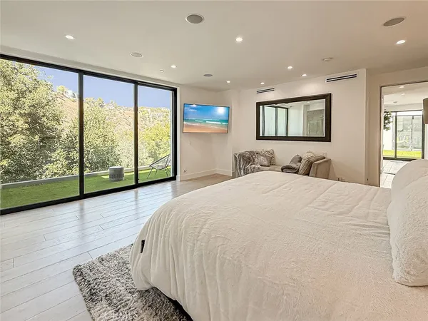 a bedroom with a large bed and a large window