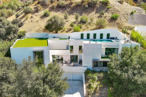 an aerial view of a house with a yard