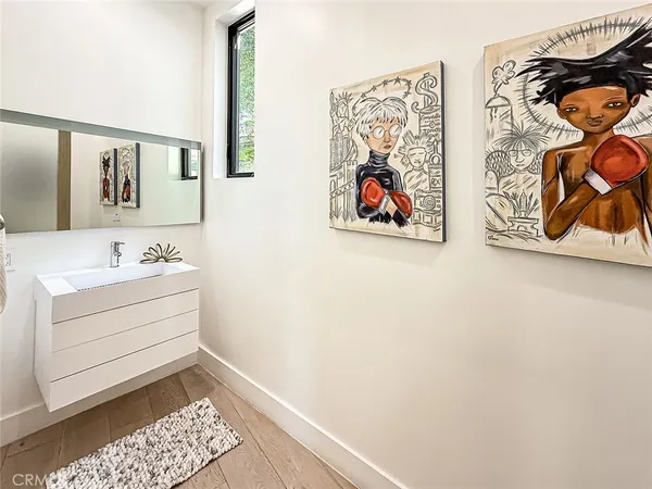 a bathroom with a sink and a picture on the wall