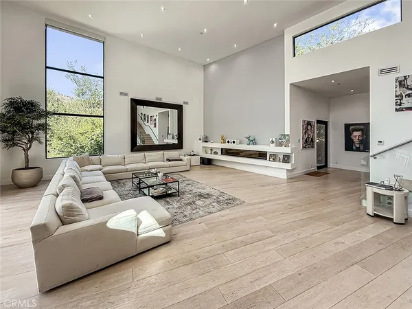a living room with furniture and large windows