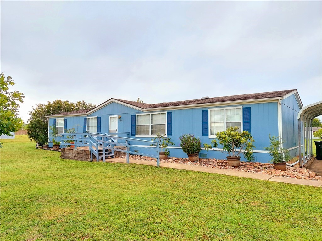 a front view of house with yard seating and patio