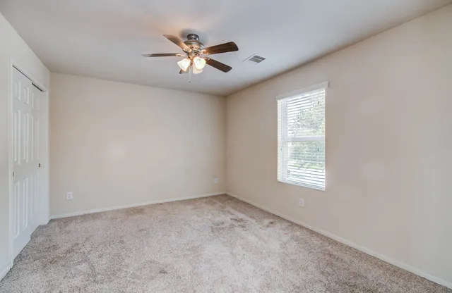 a view of a chandelier fan and closet area