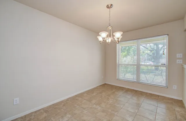 a view of a chandelier in big room and chandelier