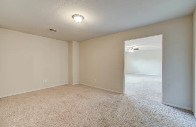 a spacious bathroom with a double vanity sink a mirror and a toilet