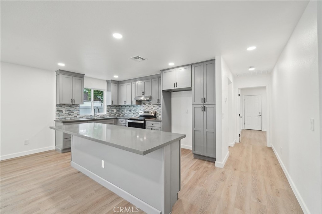 4664 Sierra Street Riverside, CA 92504 - Photo 1 of 30 a kitchen with stainless steel appliances a refrigerator sink and cabinets