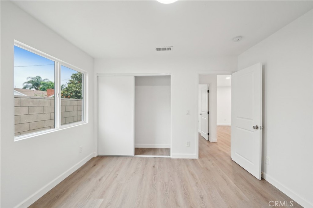 4664 Sierra Street Riverside, CA 92504 - Photo 15 of 30 a view of an empty room with wooden floor and a window