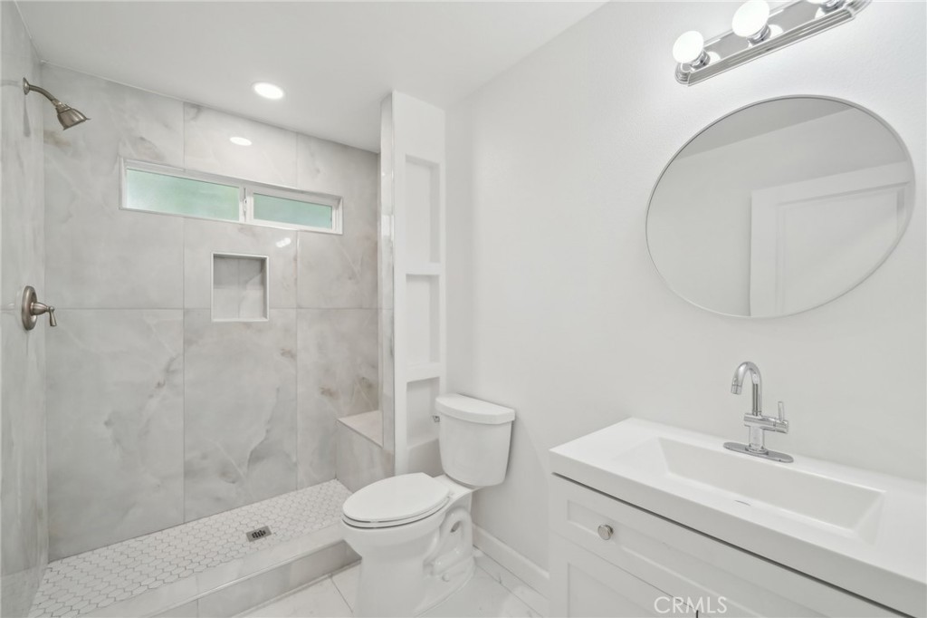 4664 Sierra Street Riverside, CA 92504 - Photo 21 of 30 a bathroom with a sink a toilet and shower