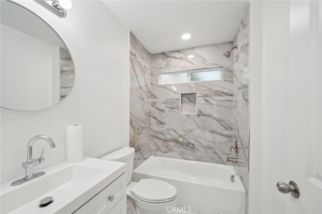 4664 Sierra Street Riverside, CA 92504 - Photo 25 of 30 a bathroom with a bathtub shower sink vanity mirror and toilet