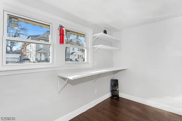 a room with a bench and painting on the wall