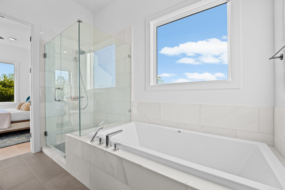 5001 Childers Path Austin, TX 78741 - Photo 24 of 40 Ensuite bathroom featuring a garden tub, a shower stall, and tile patterned flooring