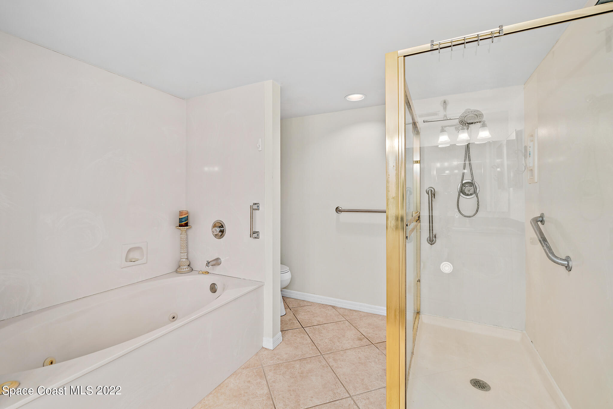 6770 Ridgewood Avenue, Unit 502 Cocoa Beach, FL 32931 - Photo 13 of 25 a bathroom with a bathtub and a shower