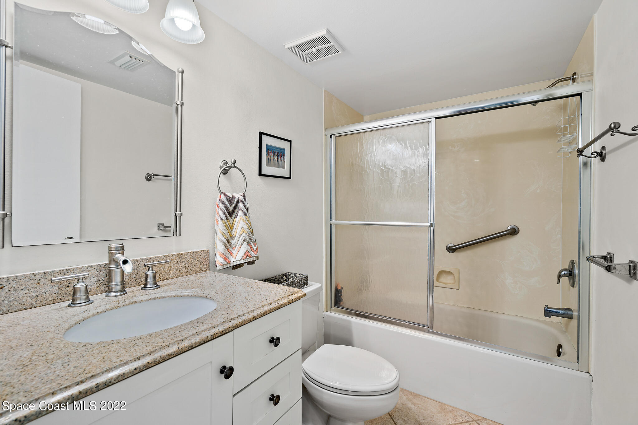 6770 Ridgewood Avenue, Unit 502 Cocoa Beach, FL 32931 - Photo 15 of 25 a bathroom with a granite countertop sink toilet and shower