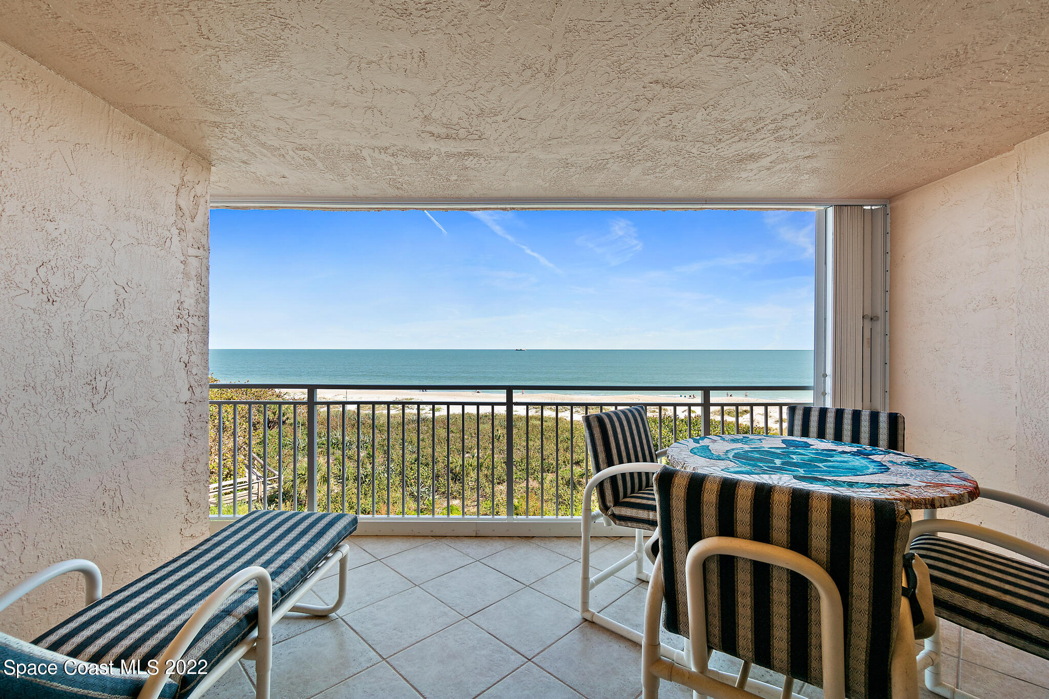6770 Ridgewood Avenue, Unit 502 Cocoa Beach, FL 32931 - Photo 16 of 25 a view of a balcony with chairs