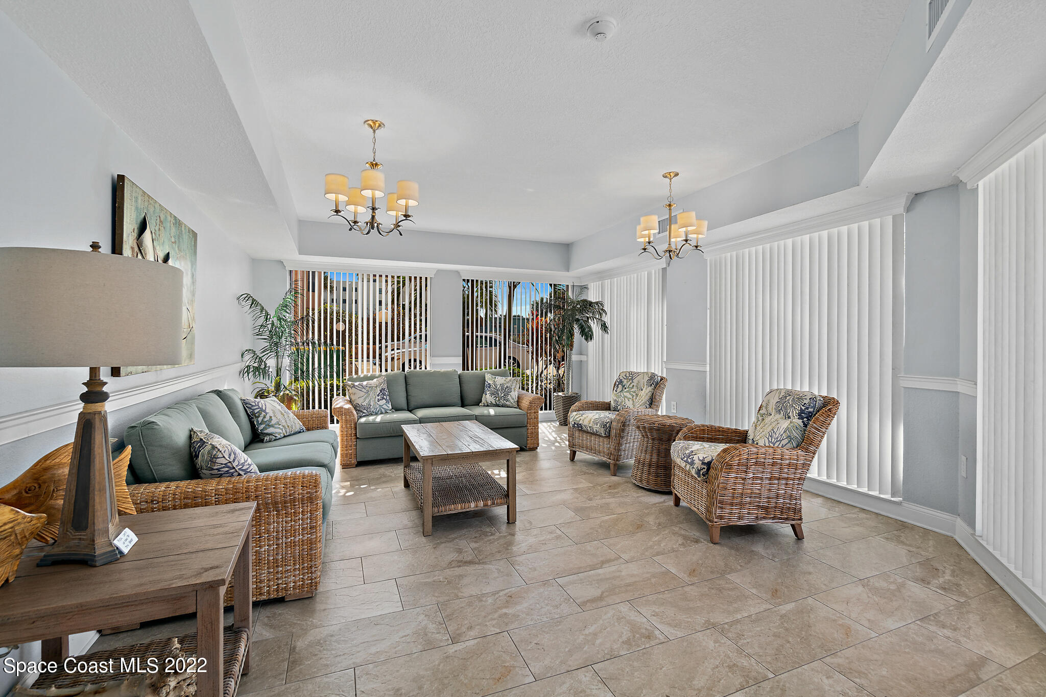 6770 Ridgewood Avenue, Unit 502 Cocoa Beach, FL 32931 - Photo 20 of 25 a living room with furniture and a chandelier