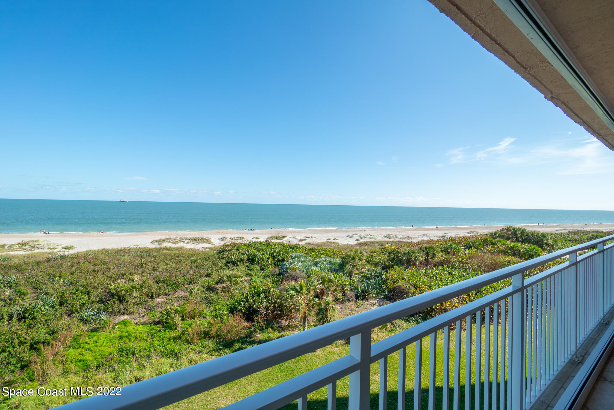 6770 Ridgewood Avenue, Unit 502 Cocoa Beach, FL 32931 - Photo 2 of 25 a view of city and mountain from a balcony