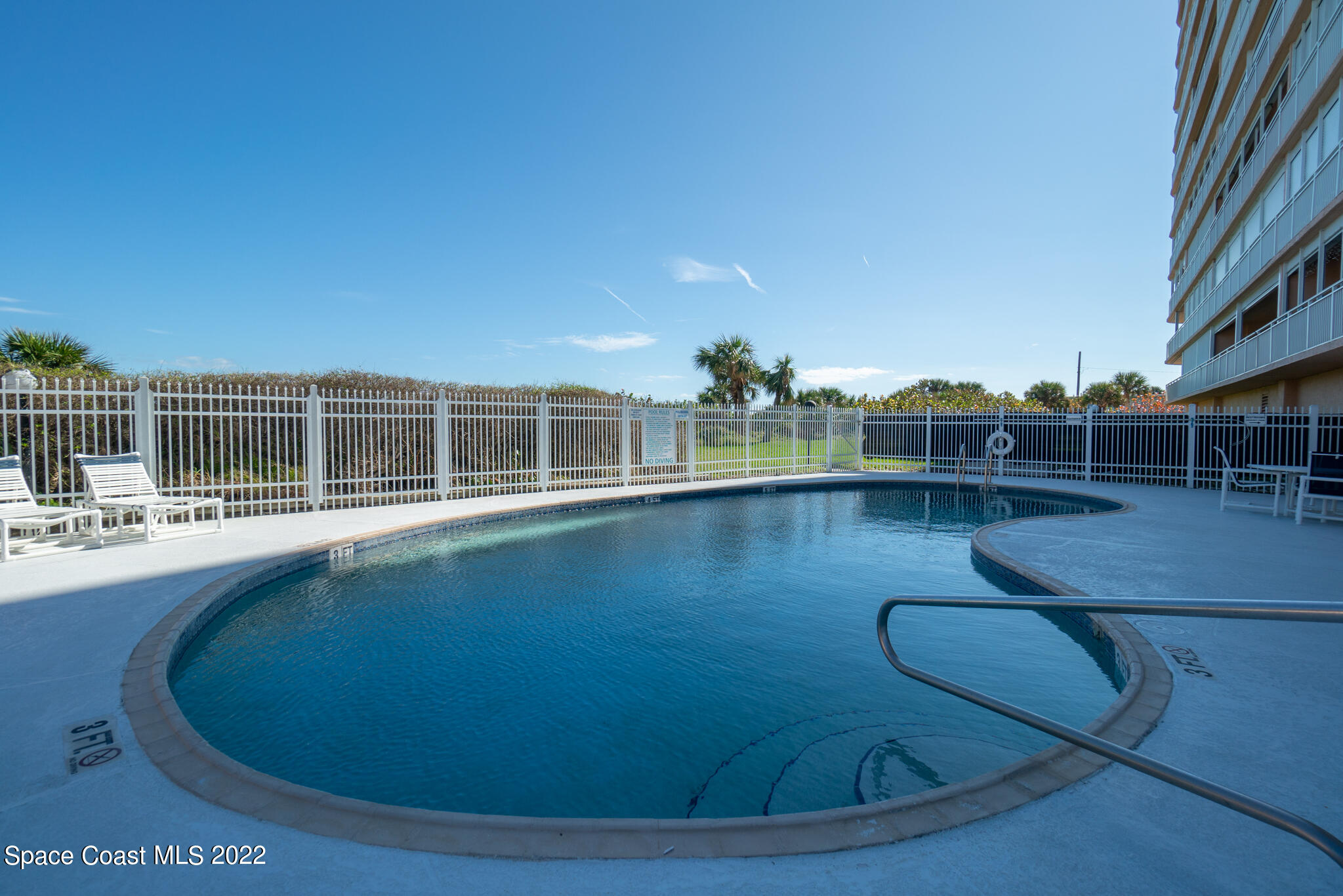 6770 Ridgewood Avenue, Unit 502 Cocoa Beach, FL 32931 - Photo 22 of 25 a view of a swimming pool with seating space