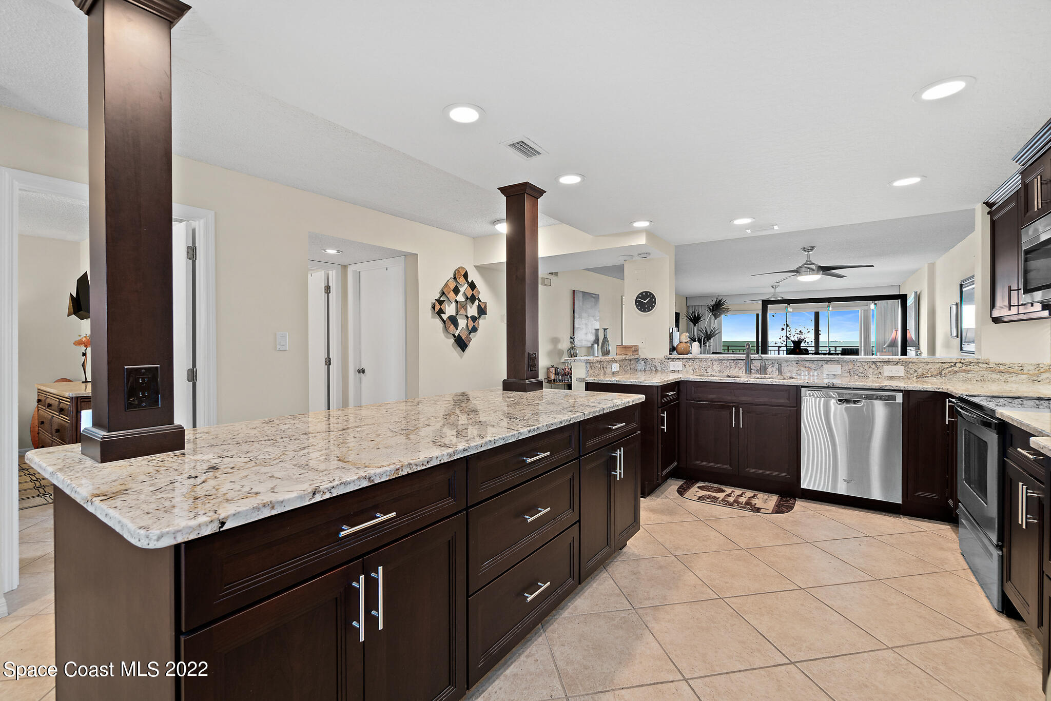6770 Ridgewood Avenue, Unit 502 Cocoa Beach, FL 32931 - Photo 3 of 25 a kitchen with a sink a counter top space and cabinets