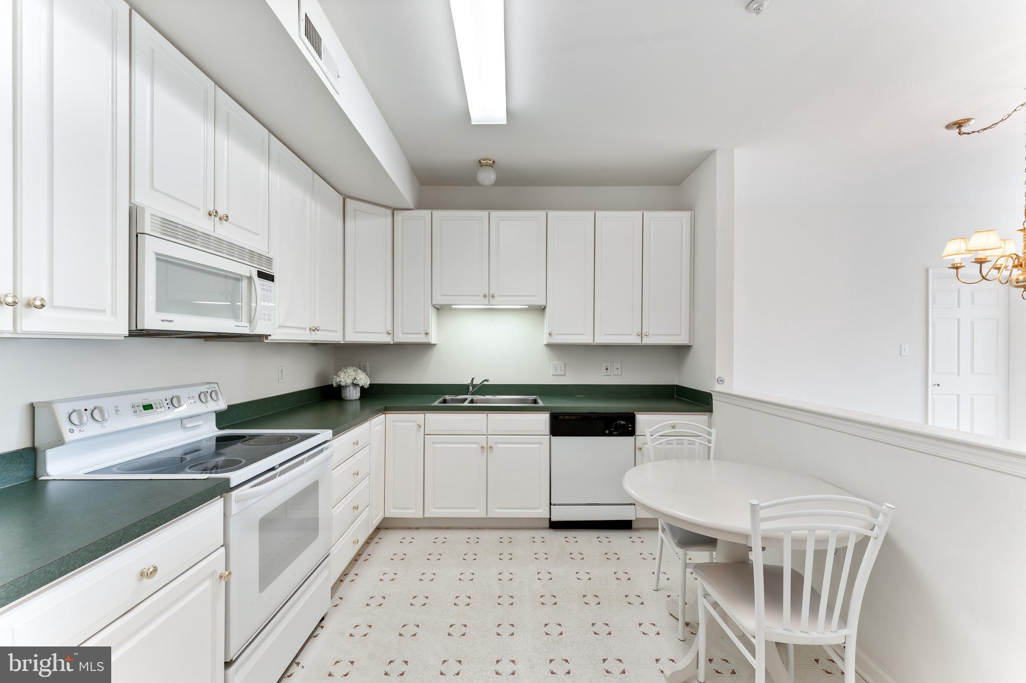 1552 Palmer Drive Springfield, PA 19064 - Photo 12 of 23 a kitchen with granite countertop a sink a stove a microwave and cabinets