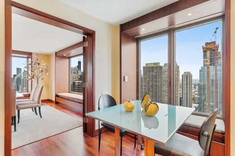 a view of a dining room with furniture window and outside view