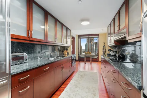 a kitchen with stainless steel appliances granite countertop a sink and stove