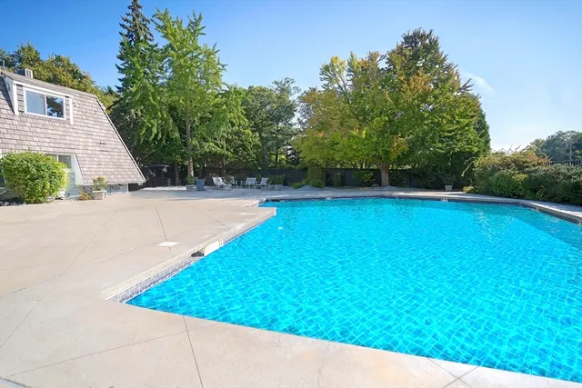 a view of a swimming pool with an outdoor space and seating area