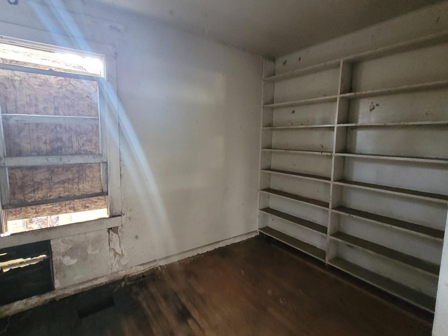 4613 Maryland Street Gary, IN 46409 - Photo 9 of 14 a view of an empty room with wooden floor and windows