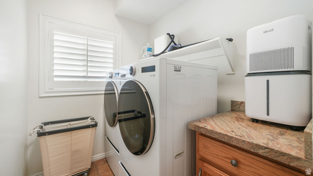 11128 South Barrett Pk Circle Sandy, UT 84092 - Photo 14 of 36 Functional laundry area featuring neutral wall tones, a window with plantation shutters, wood-finish flooring, a built-in countertop, and wood cabinetry