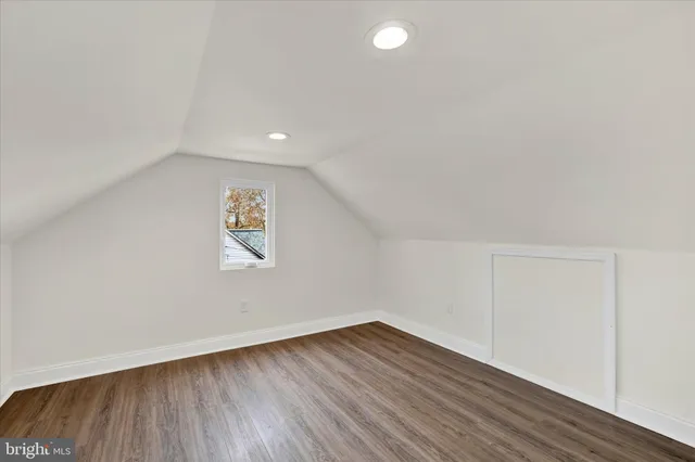 a view of an empty room and wooden floor
