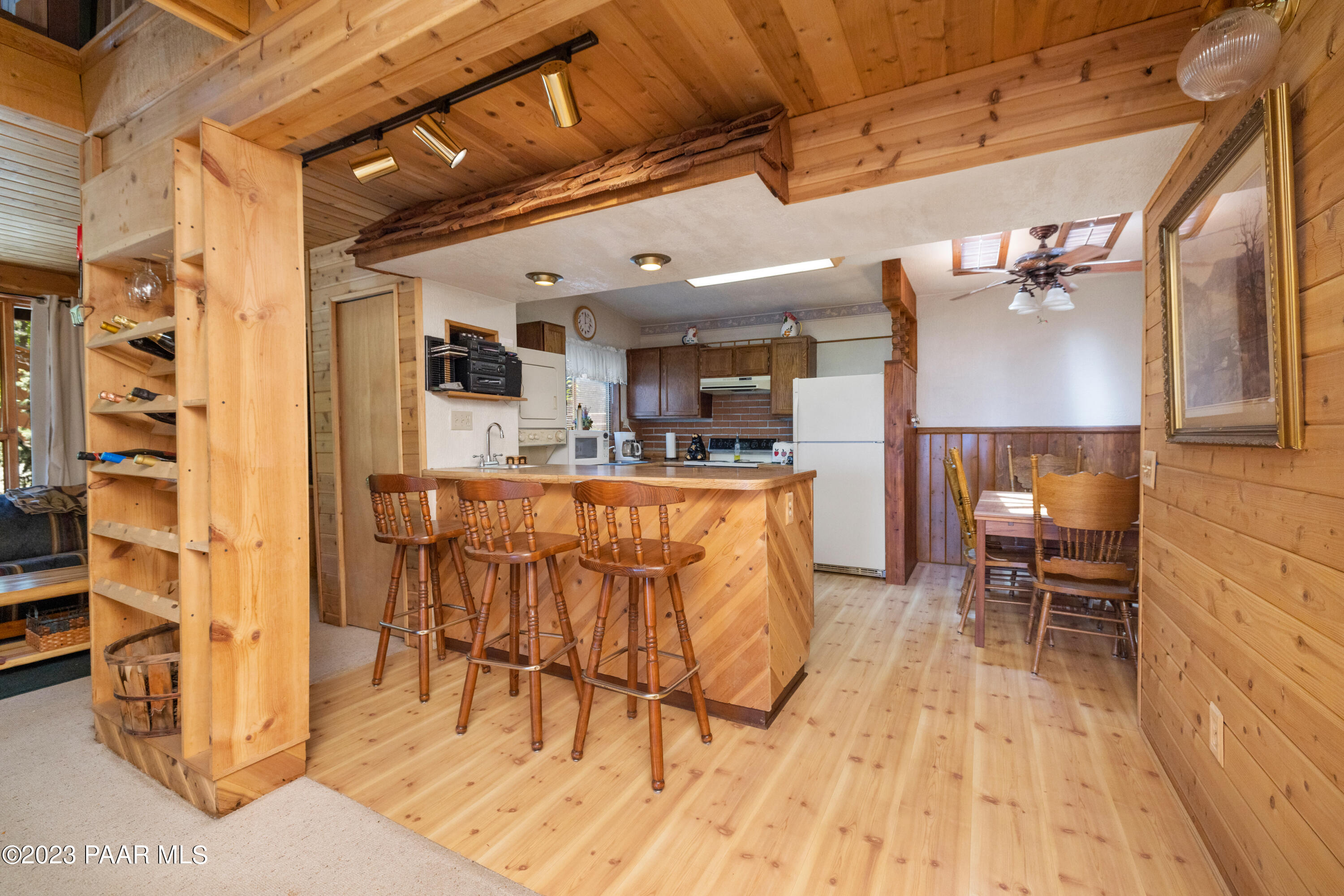 8434 Mountain View Road Mayer, AZ 86333 - Photo 16 of 33 a living room with stainless steel appliances kitchen island granite countertop furniture and a wooden floor