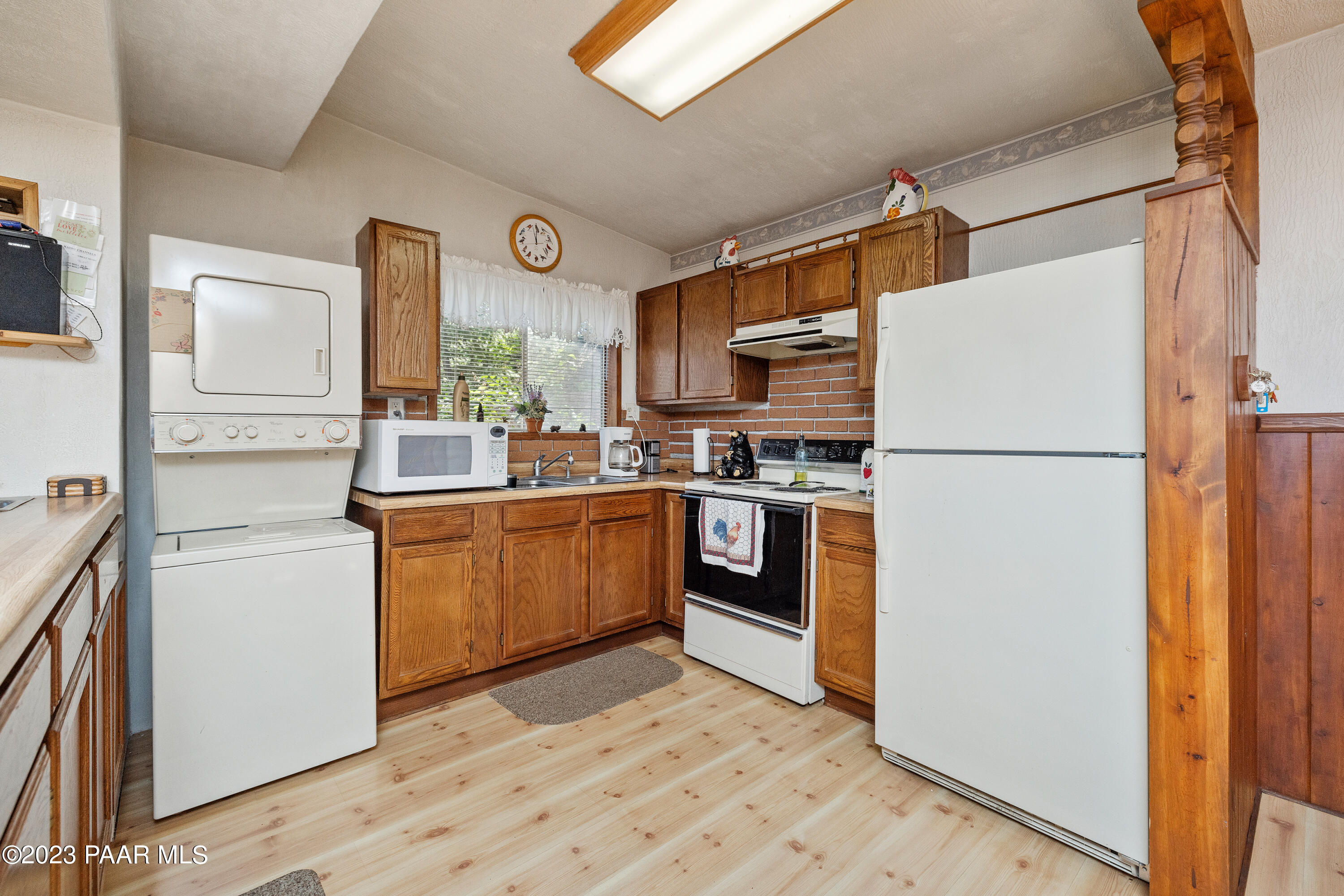 8434 Mountain View Road Mayer, AZ 86333 - Photo 17 of 33 a kitchen with stainless steel appliances a refrigerator sink and cabinets