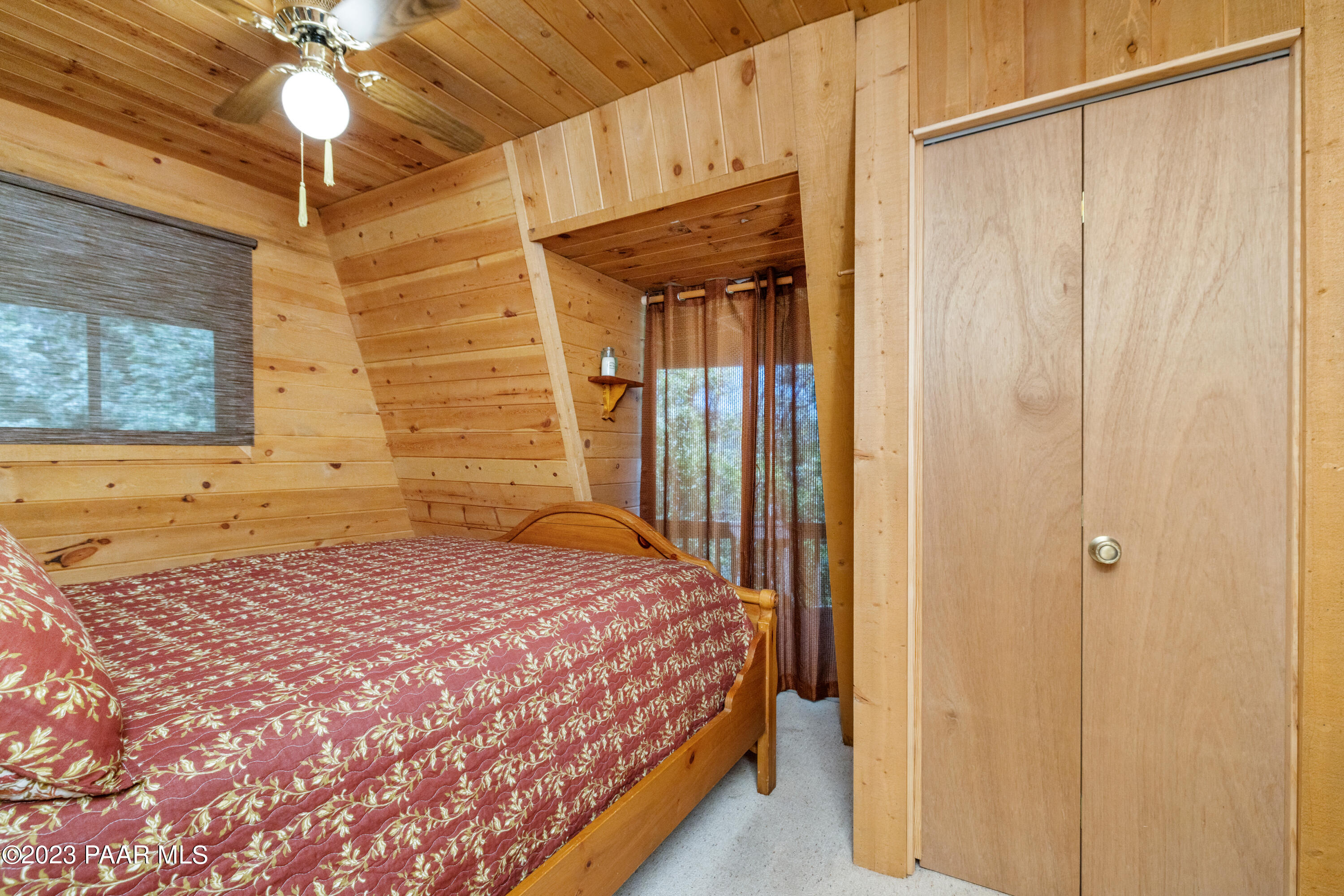 8434 Mountain View Road Mayer, AZ 86333 - Photo 19 of 33 a bedroom with a bed and a chandelier