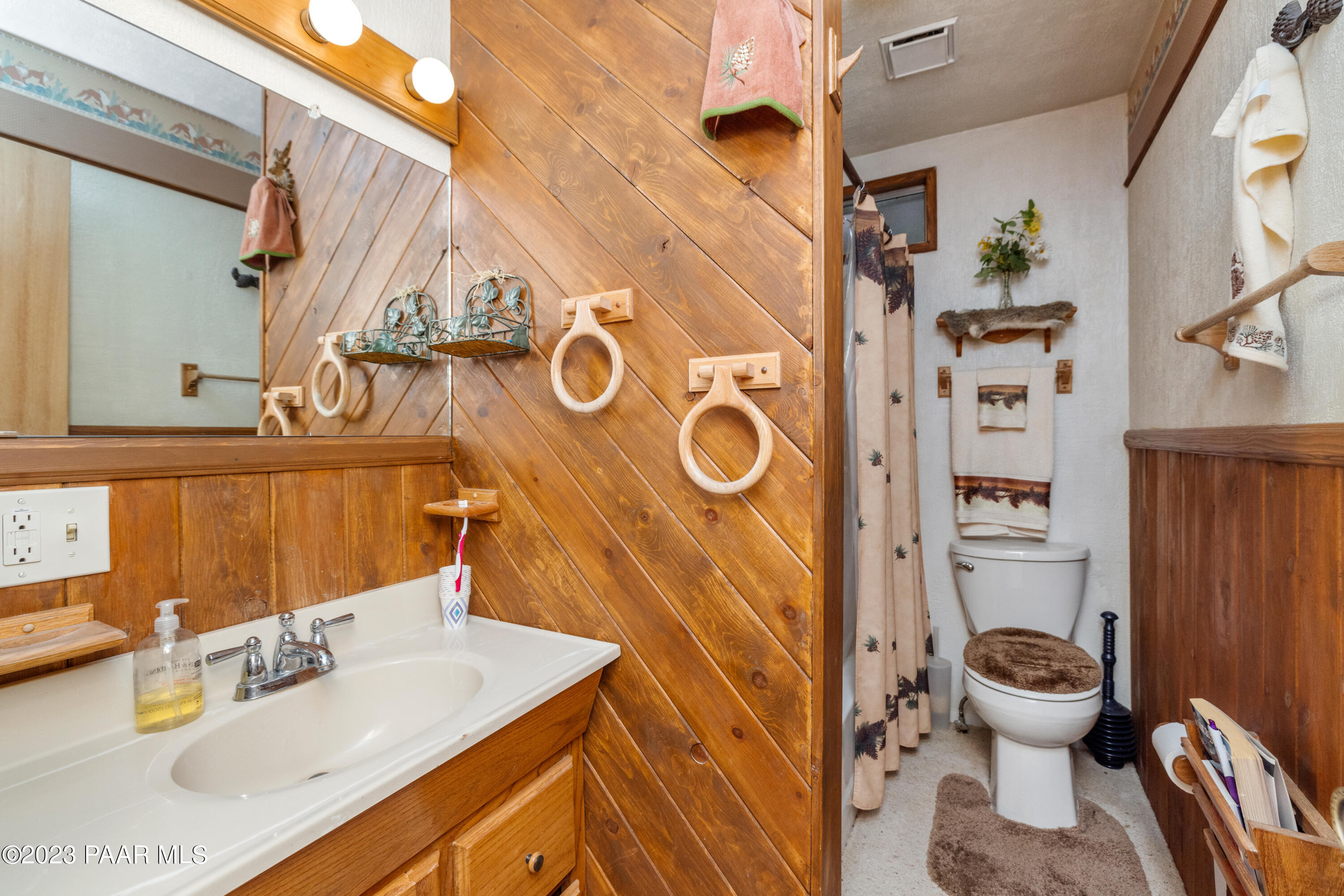 8434 Mountain View Road Mayer, AZ 86333 - Photo 21 of 33 a bathroom with a sink a toilet and a mirror